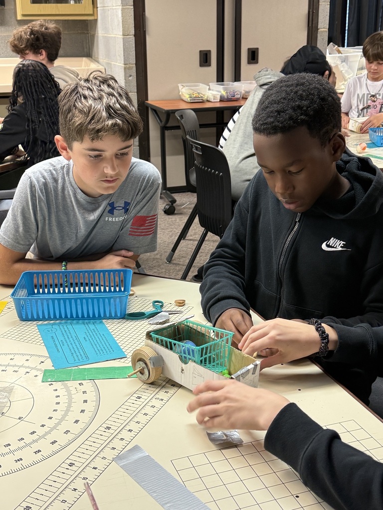 Students creating a car on a field trip.