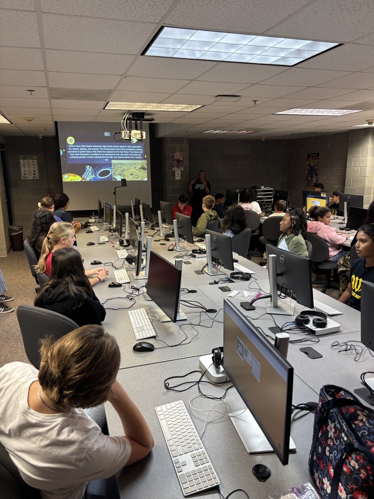 Students viewing presentation and listening to the field trip facilitator.