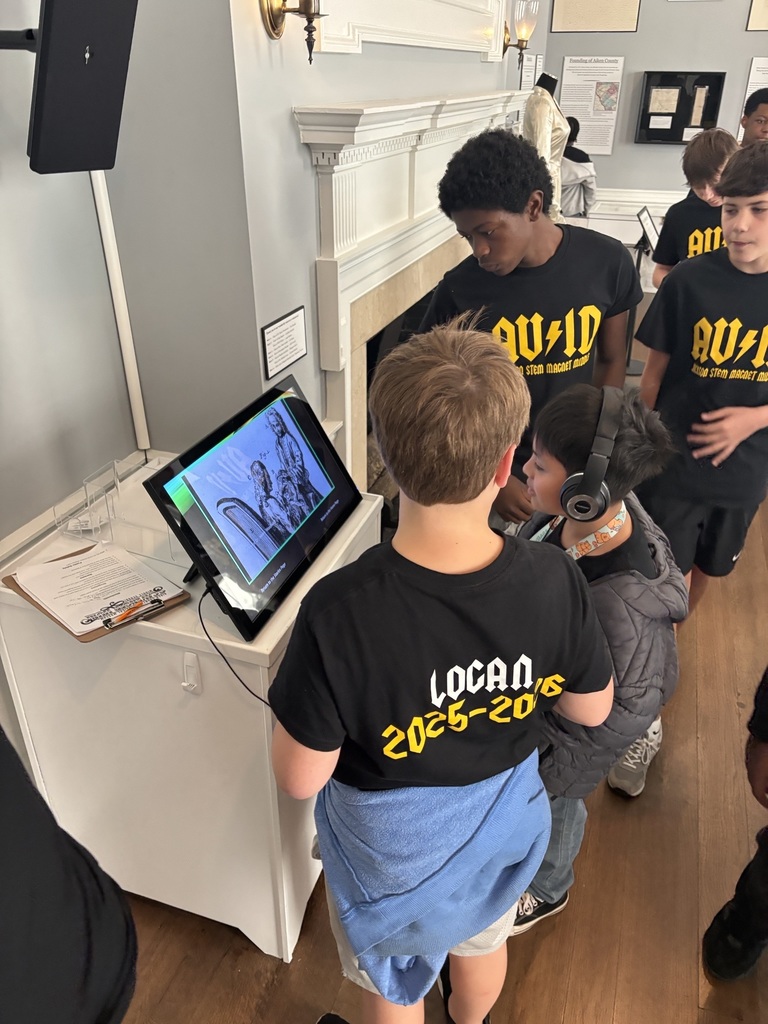 Student viewing museum technology display.