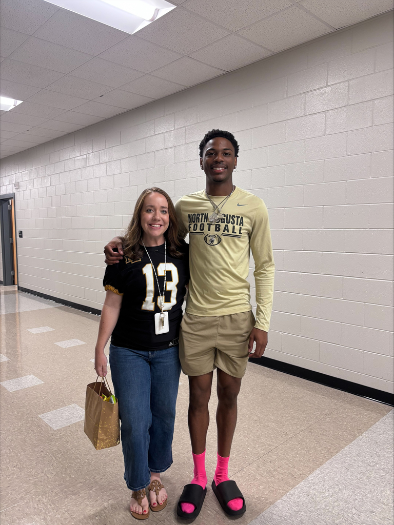 Teacher with football jersey and senior football player.