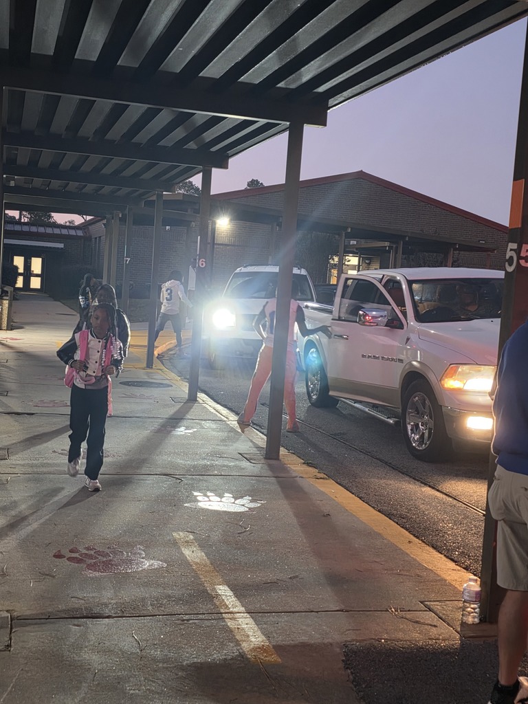 Students walking and football players opening car doors.