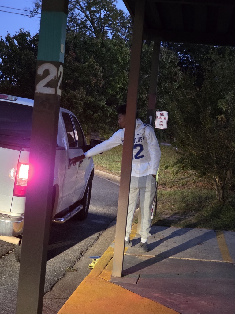Football player opening car door.