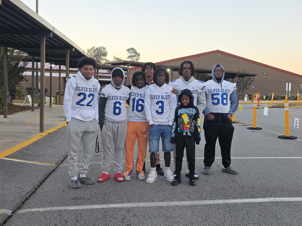 Football players in crosswalk.