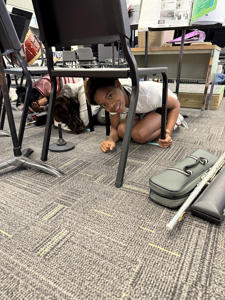 students under a chair 