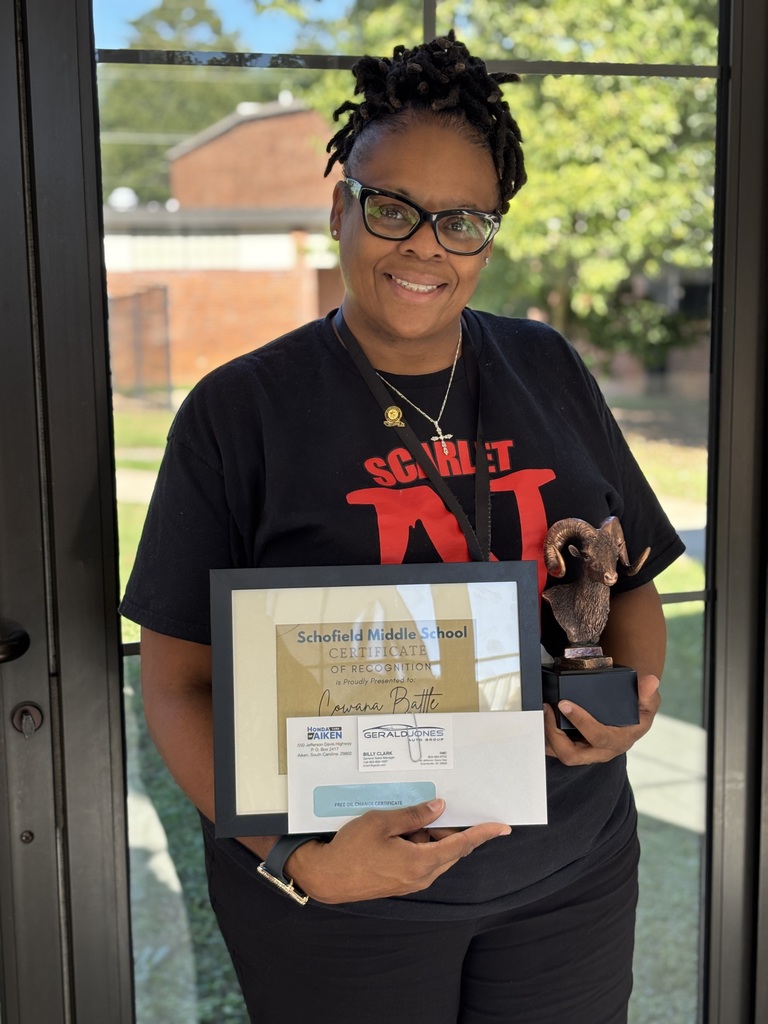 Picture of a lady holding a plaque
