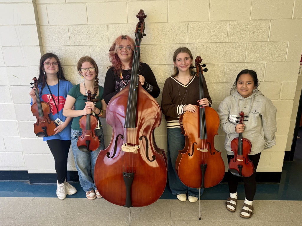 Students holding their orchestra instruments