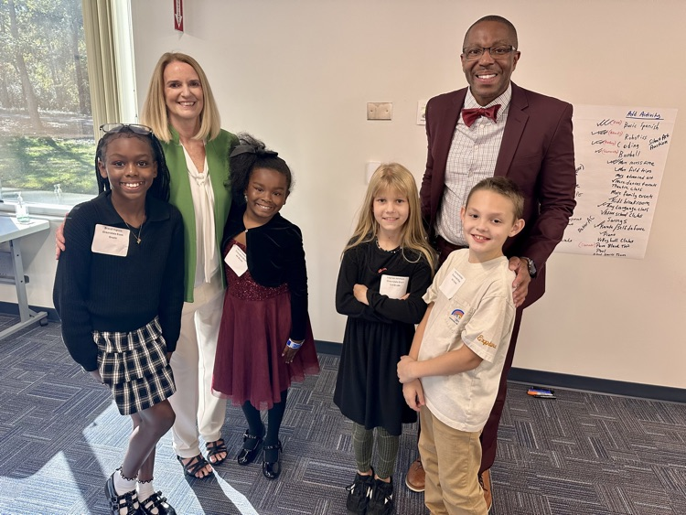 Students standing with the asst superintendents of elementary. 