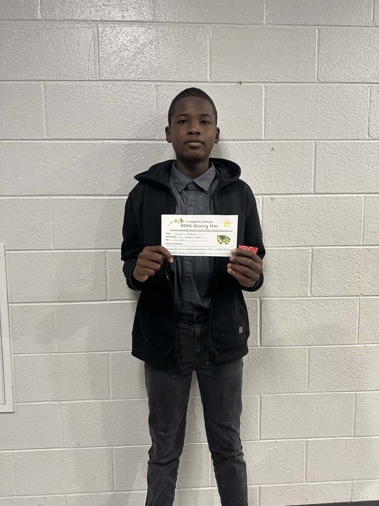 student holding an award, posing for a picture 