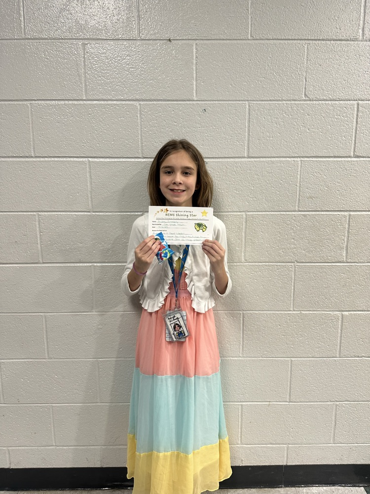 student holding an award, posing for a picture 