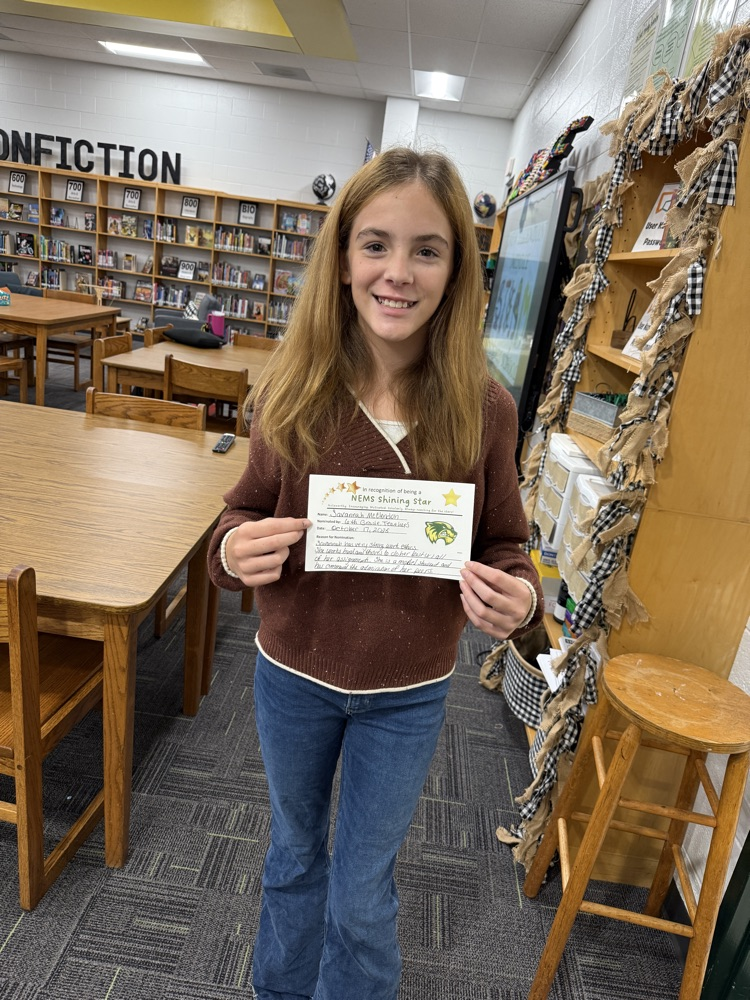 student holding an award, posing for a picture 
