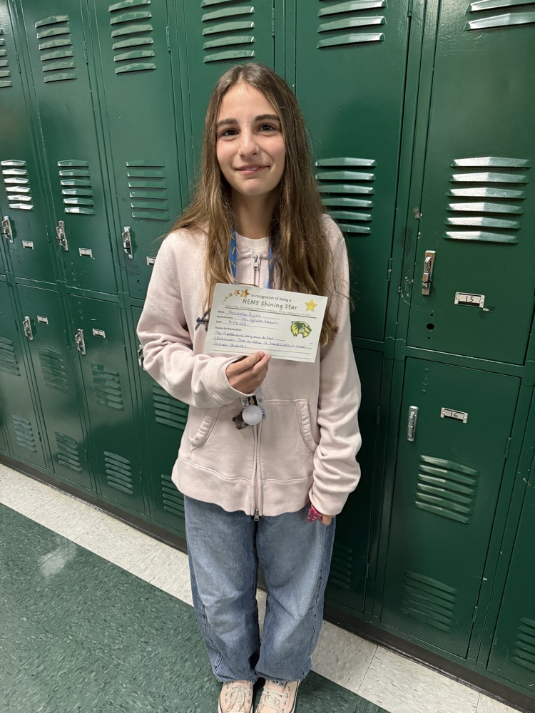 student holding an award, posing for a picture 