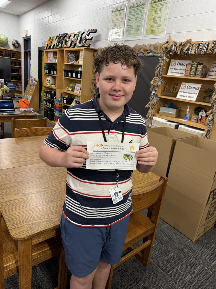 student holding an award, posing for a picture 