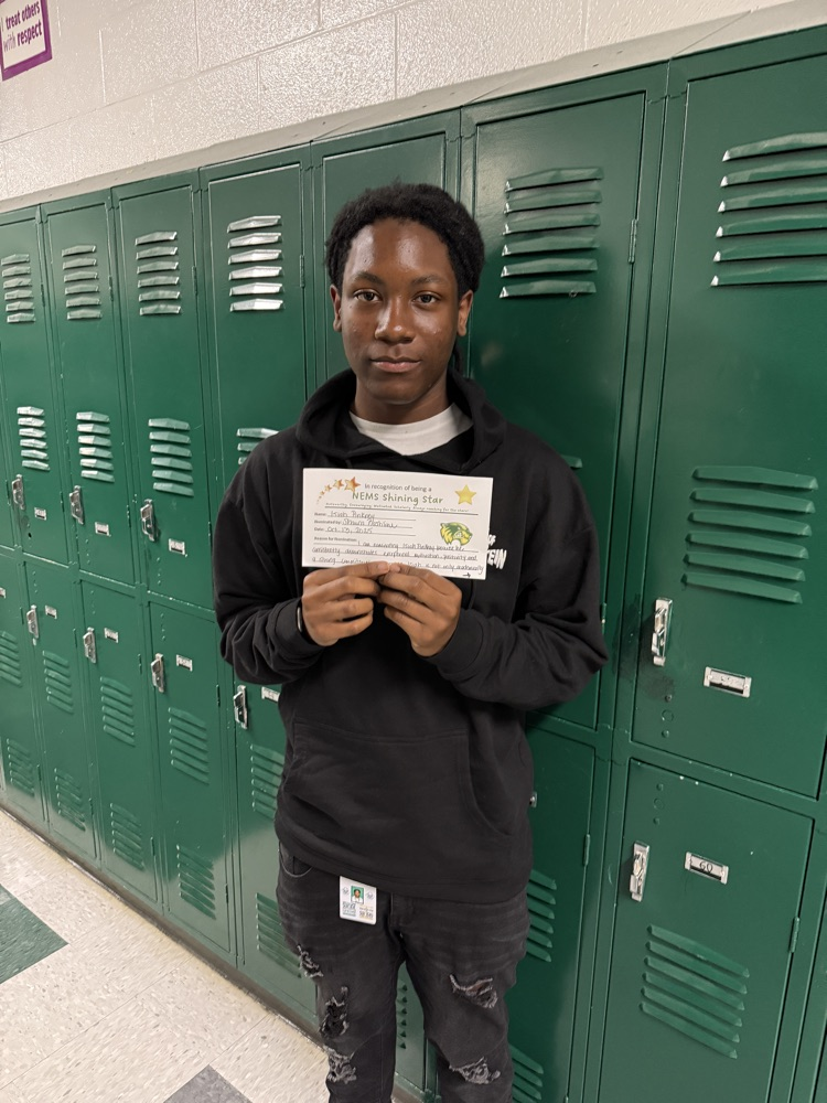 student holding an award, posing for a picture 