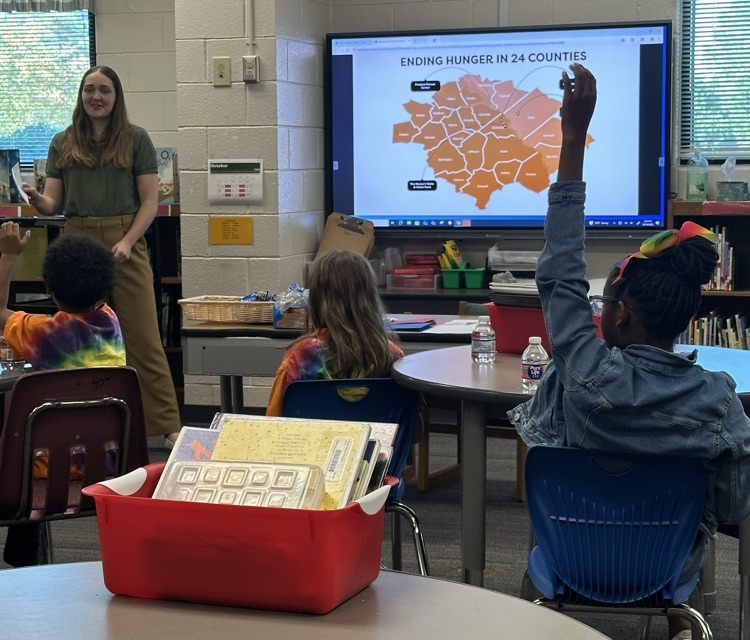 Speaker Nora Ruotolo of the Golden Harvest Food Bank speaking to students of Warrenville Cares Club