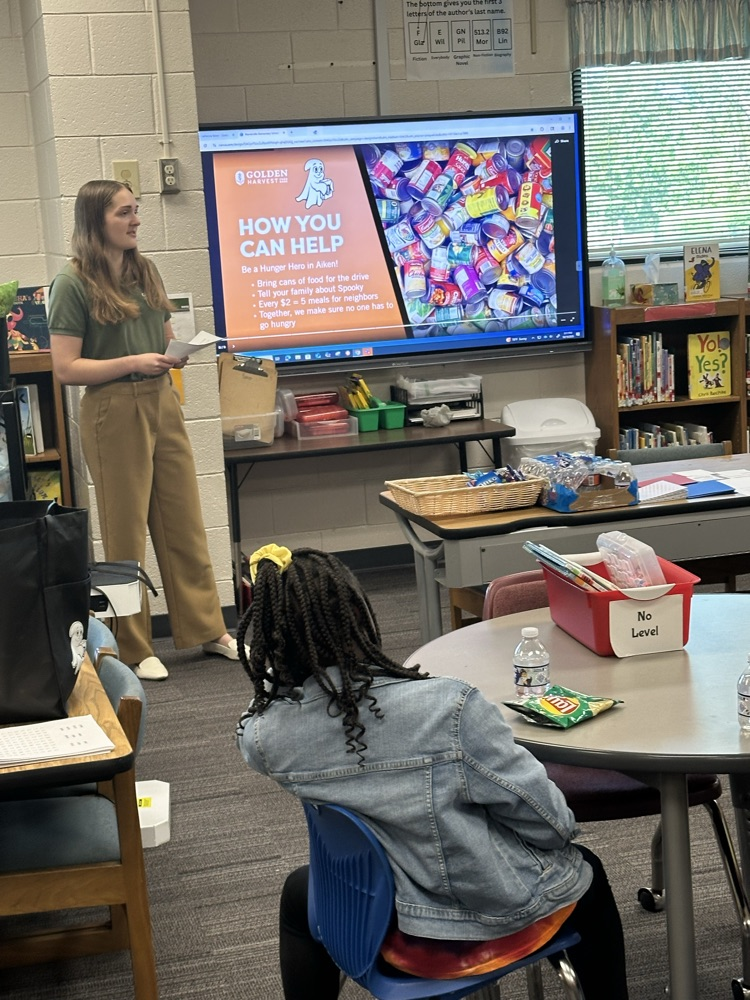 Speaker Nora Ruotolo of the Golden Harvest Food Bank speaking to students of Warrenville Cares Club