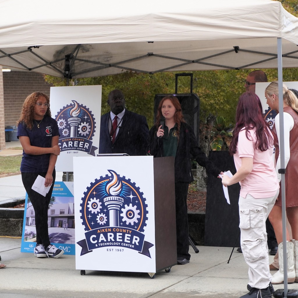 Student sharing information about a school's new logo.