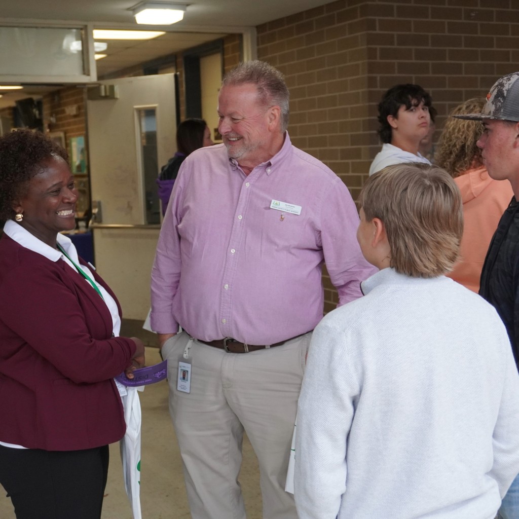 Board Members Liz Morris and Jim Broome talk with students at Community Night.