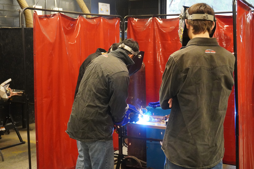 Students showcasing their welding skills for visitors during Community Night at ACCTC.
