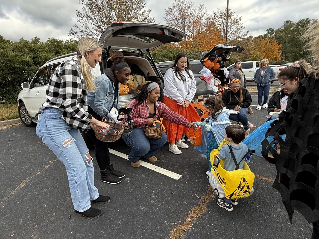 Rising teachers giving candy to young students.