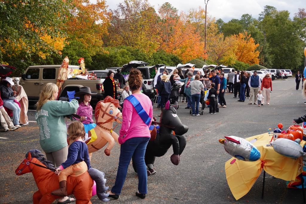 Trunk or Treat event guest touring the decorated cars.