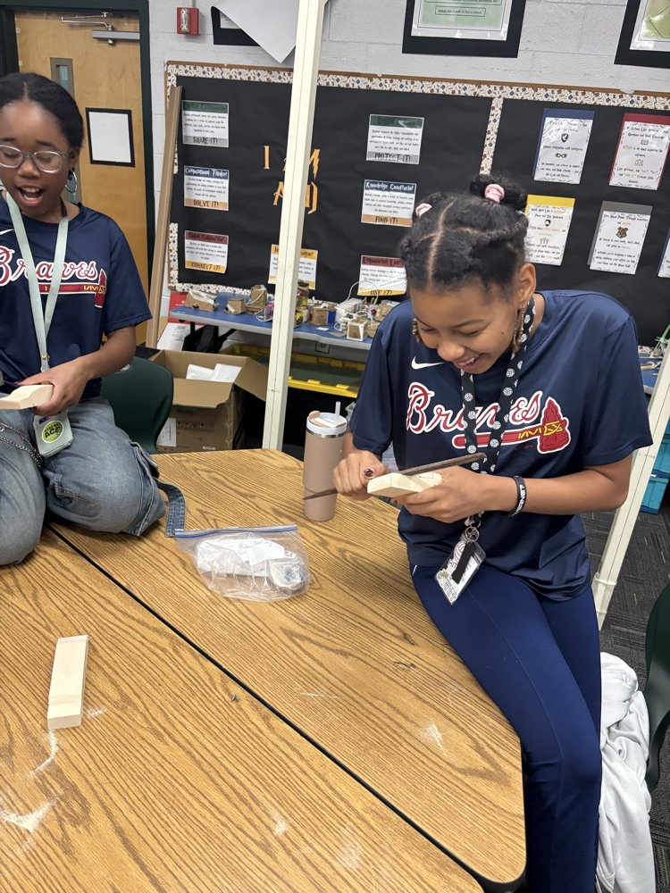 students working on pine box race cars 
