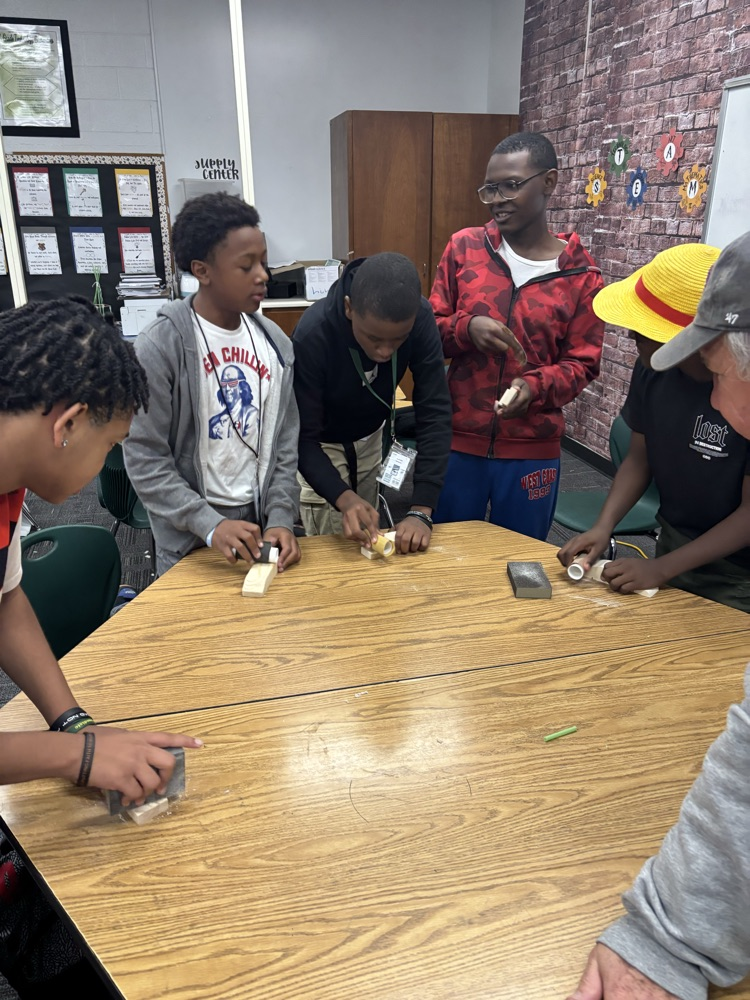 students working on pine box race cars 