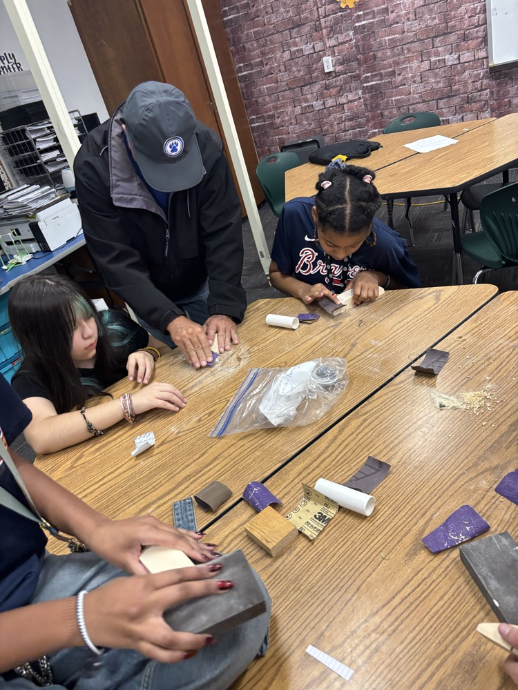 students working on pine box race cars 