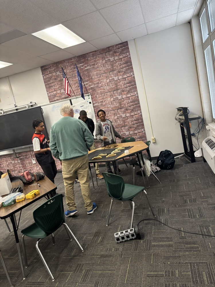 students working on pine box race cars 