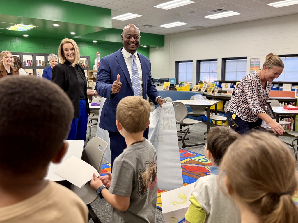 Superintendent, district, and school leaders celebrate Excellent School Report Card rating with students.