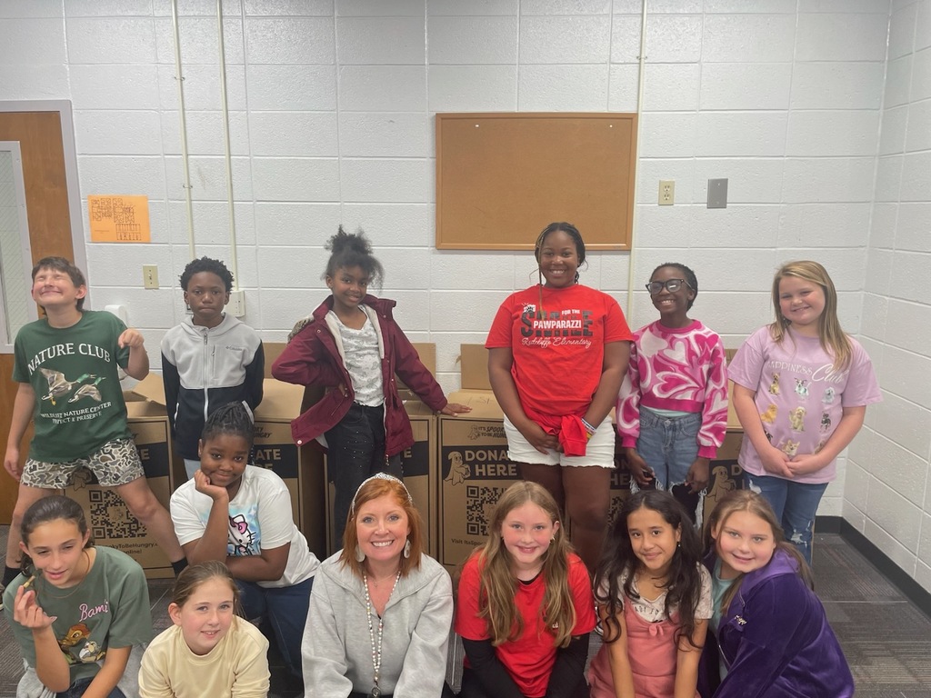 Student Council students posing with principal and collection boxes..