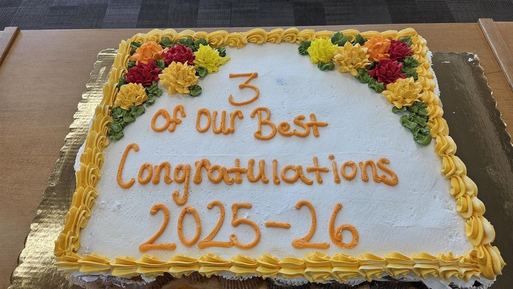 Cake with yellow and red flowers and leaves. 