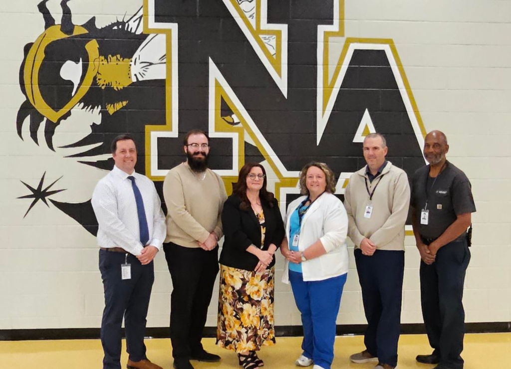 STARS of Education recipients standing in front of Jacket Logo