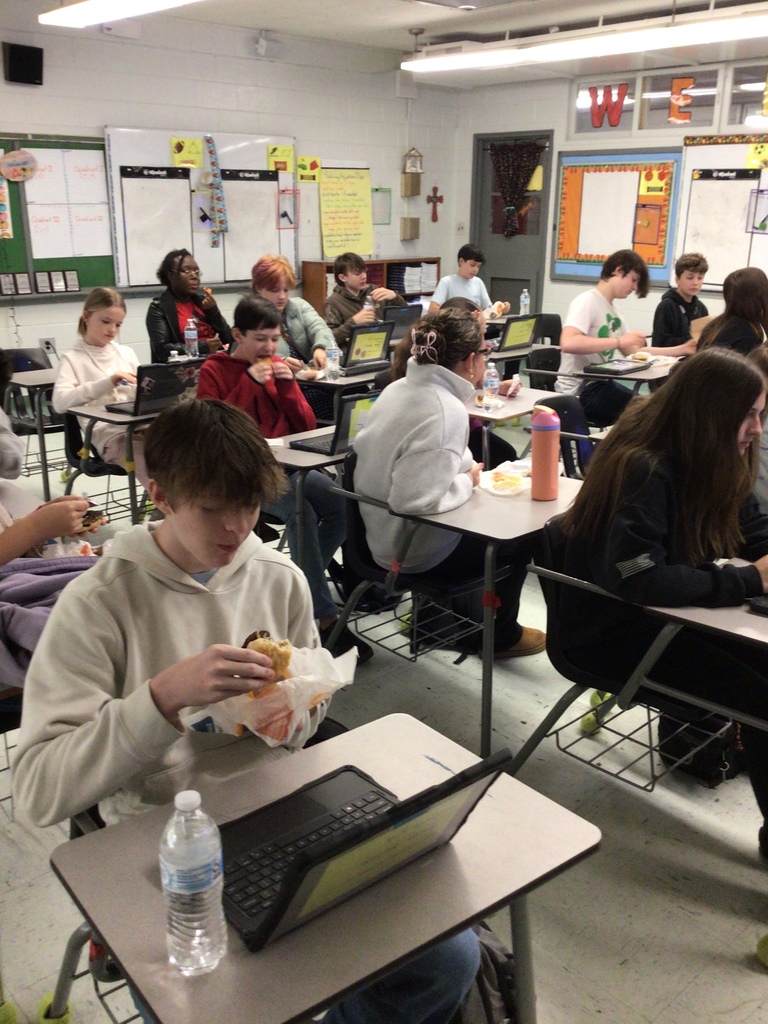 Students enjoying breakfast treat.