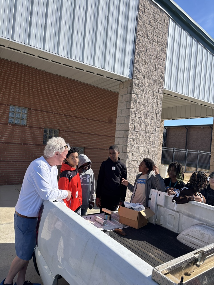 students standing around a truck 