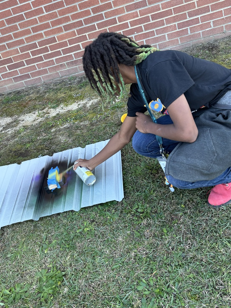 students painting pine box race cars 