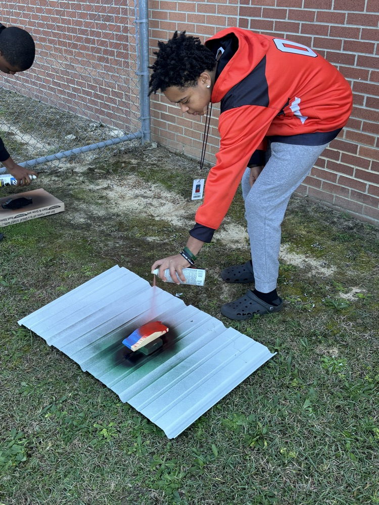 students painting pine box race cars 