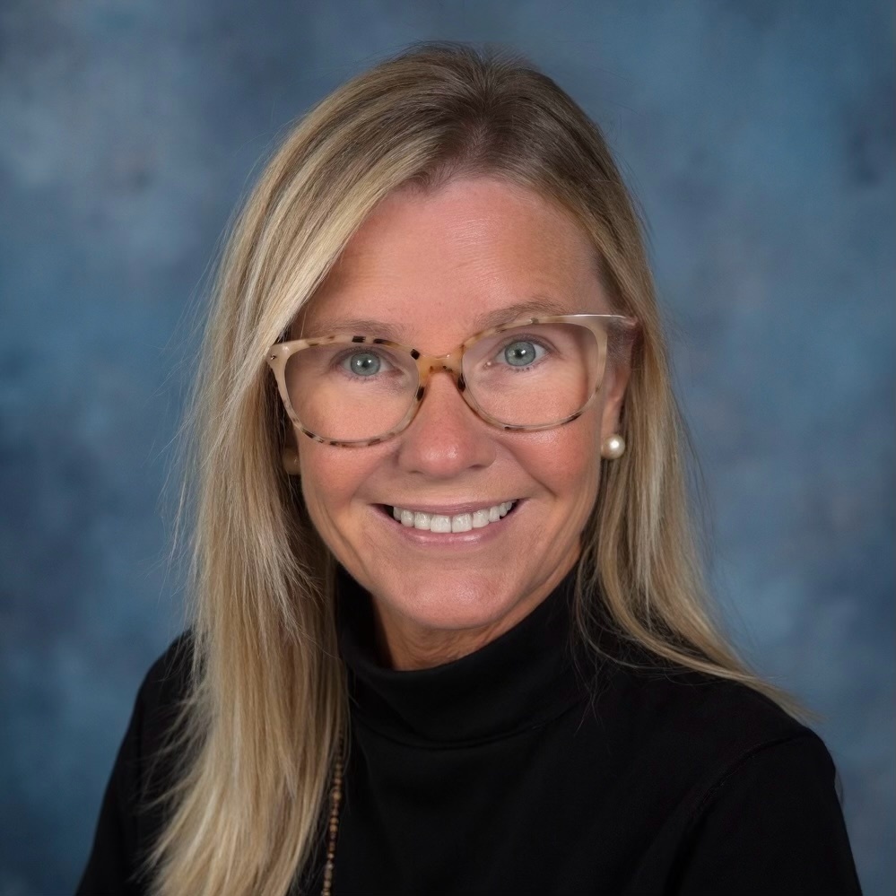 profile picture of a blonde-haired woman wearing a black shirt and glasses 