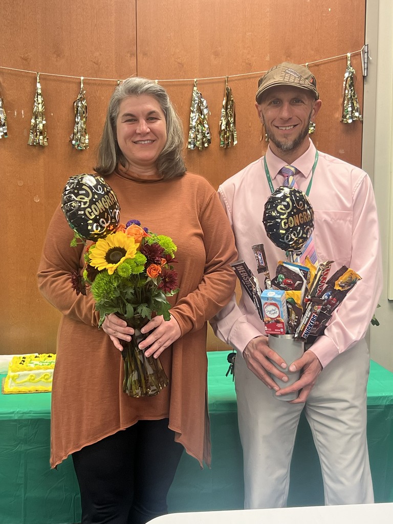 man and woman holding flowers
