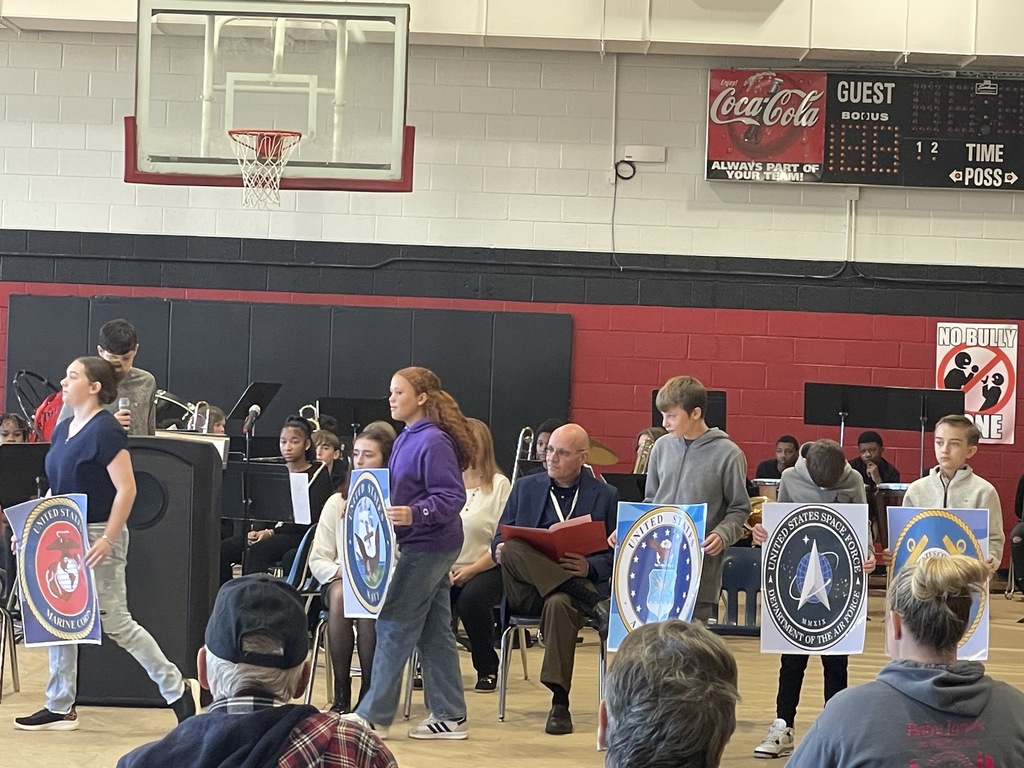 Students holding military branch signs.