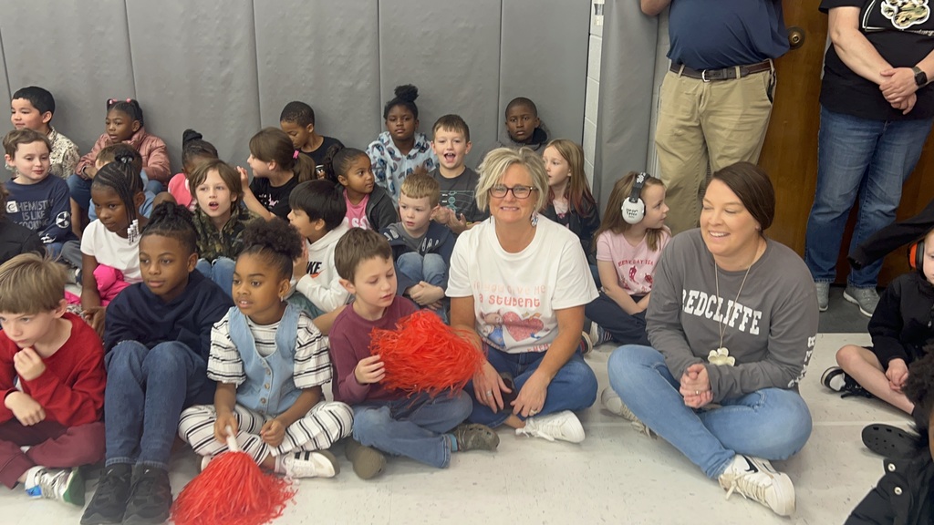 Students and teachers in pep rally audience.