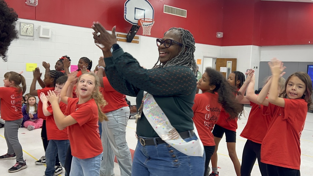 Bear Cubs and teacher dancing at pep rally.