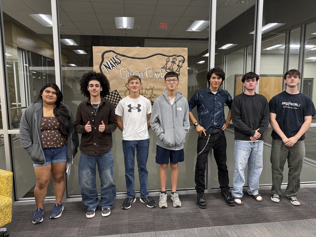 Students lined up in front of chess club sign.