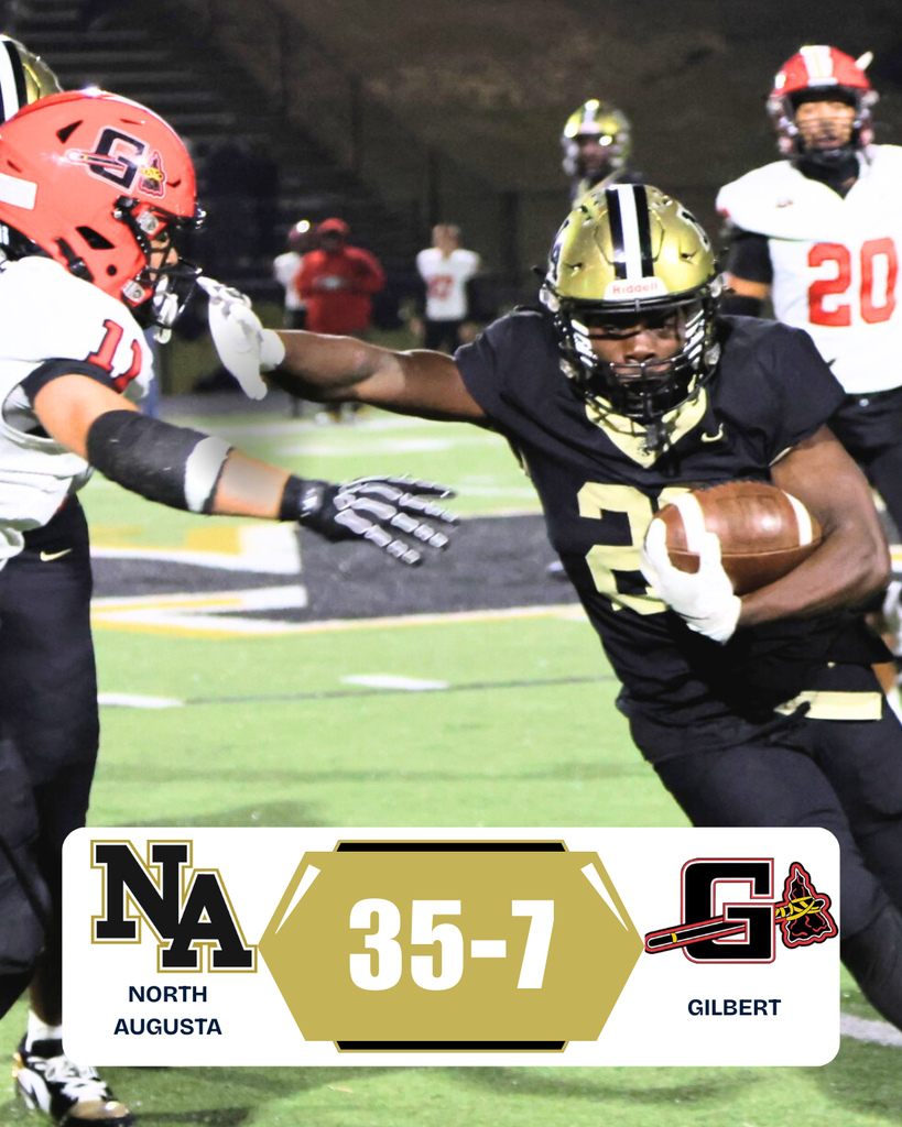 Football player fending off another player on field .with outstretched arm. 