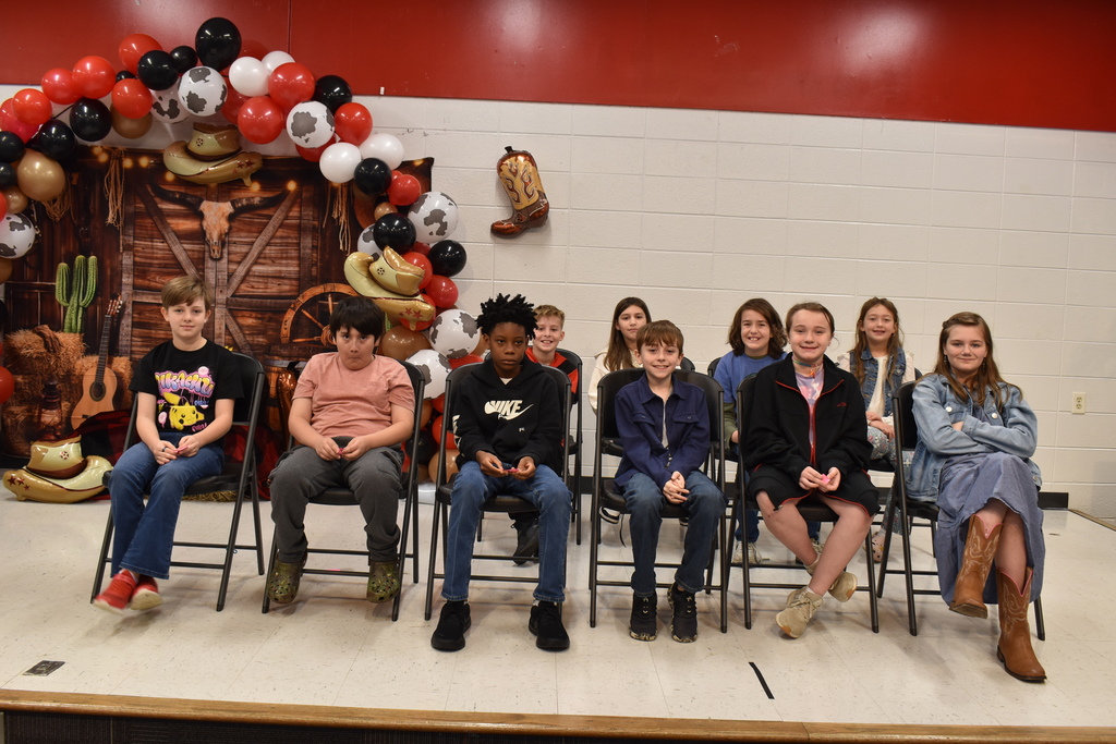 Students on stage participating in spelling bee.
