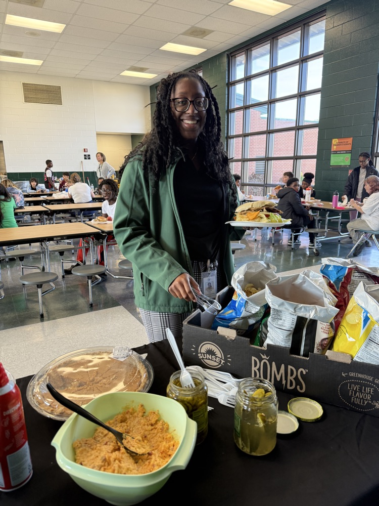 student posing with Thanksgiving lunch tray 