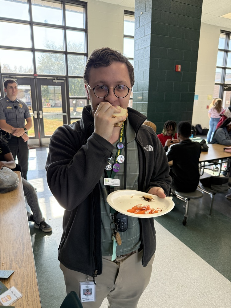 student posing with Thanksgiving lunch tray 