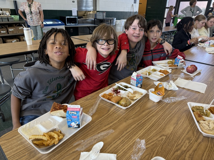 student posing with Thanksgiving lunch tray 