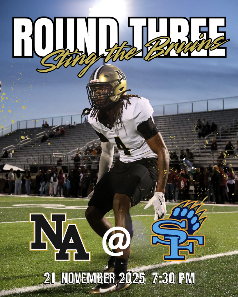 Football player in stadium with fans in background. 