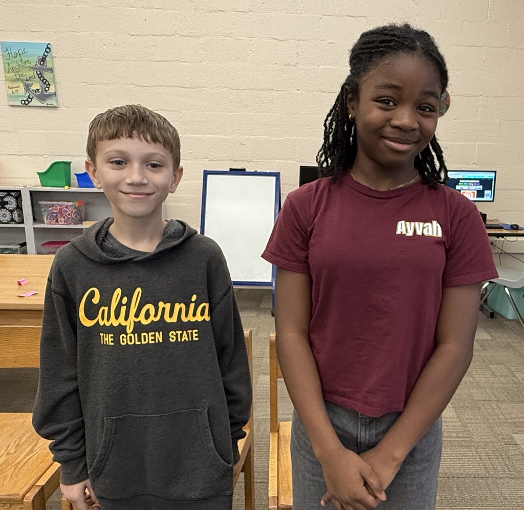 A boy is standing next to a girl.