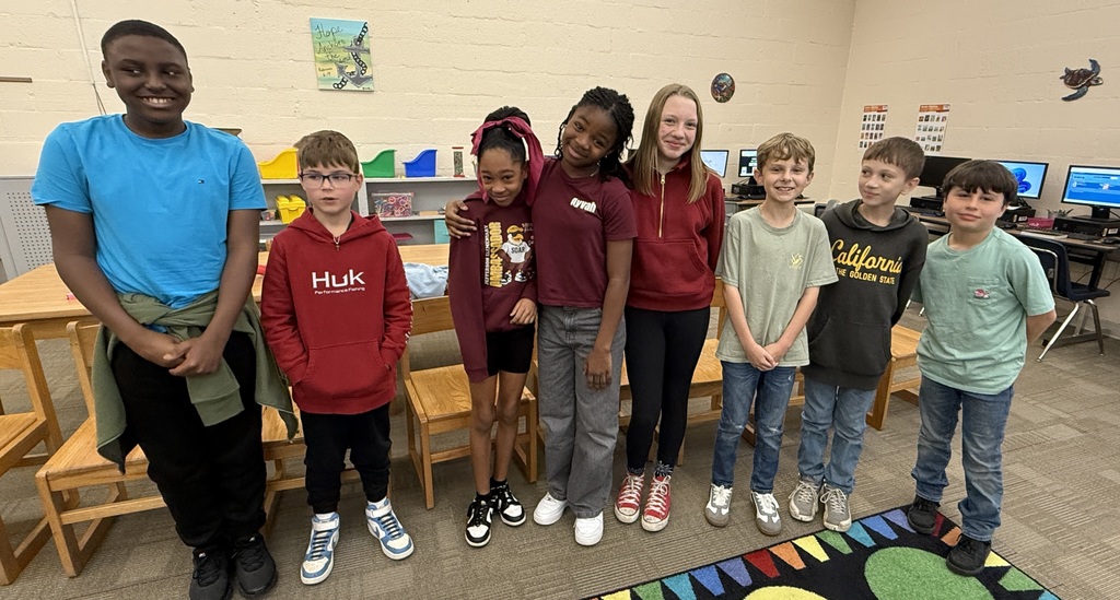 Five boys and three girls stand in a row.